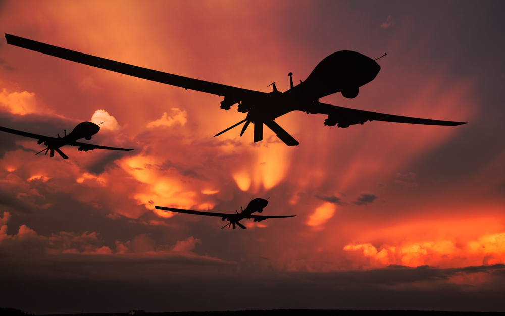 Three,Military,Drones,Silhouettes.,Armed,With,Missiles.,Yellow,Sky,Background.
