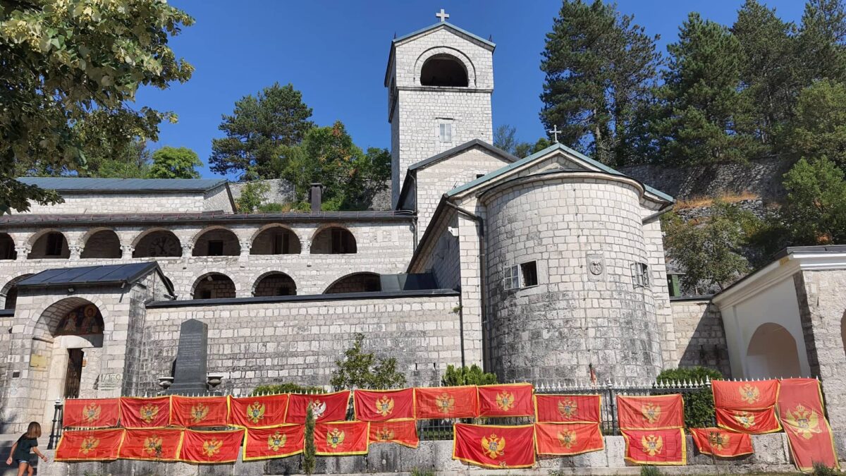Dva mjeseca traje skrnavljenje svetinje: Nadležni konačno da primijene zakon i uklone zastave sa ograde Cetinjskog manastira!
