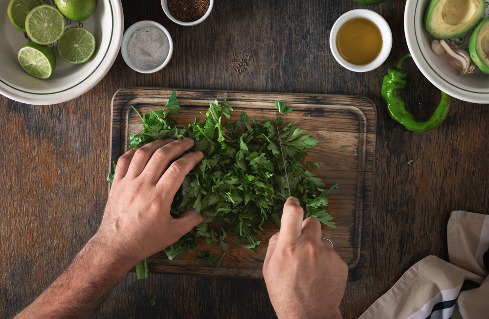 Cooking of Mexican guacamole sauce. Man preparing Mexican sauce